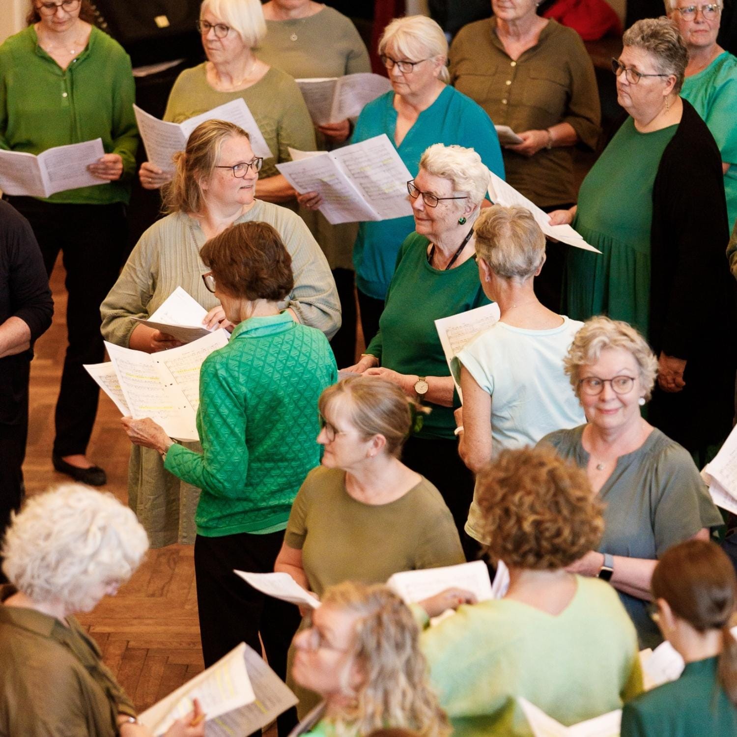 Korets medlemmer til øvning med nodepapirer og sangtekster