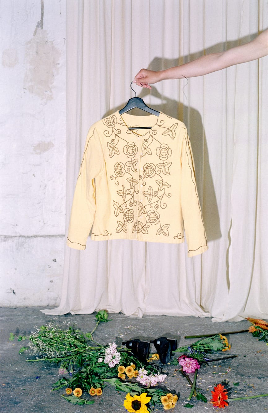 Yellow embroidered shirt held up with flowers